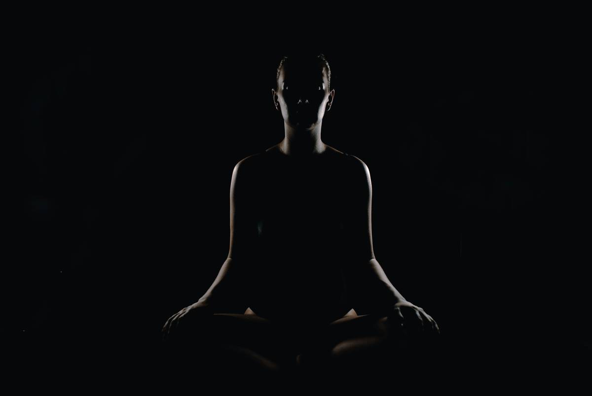 Woman practicing meditation on the go while walking through a busy city street